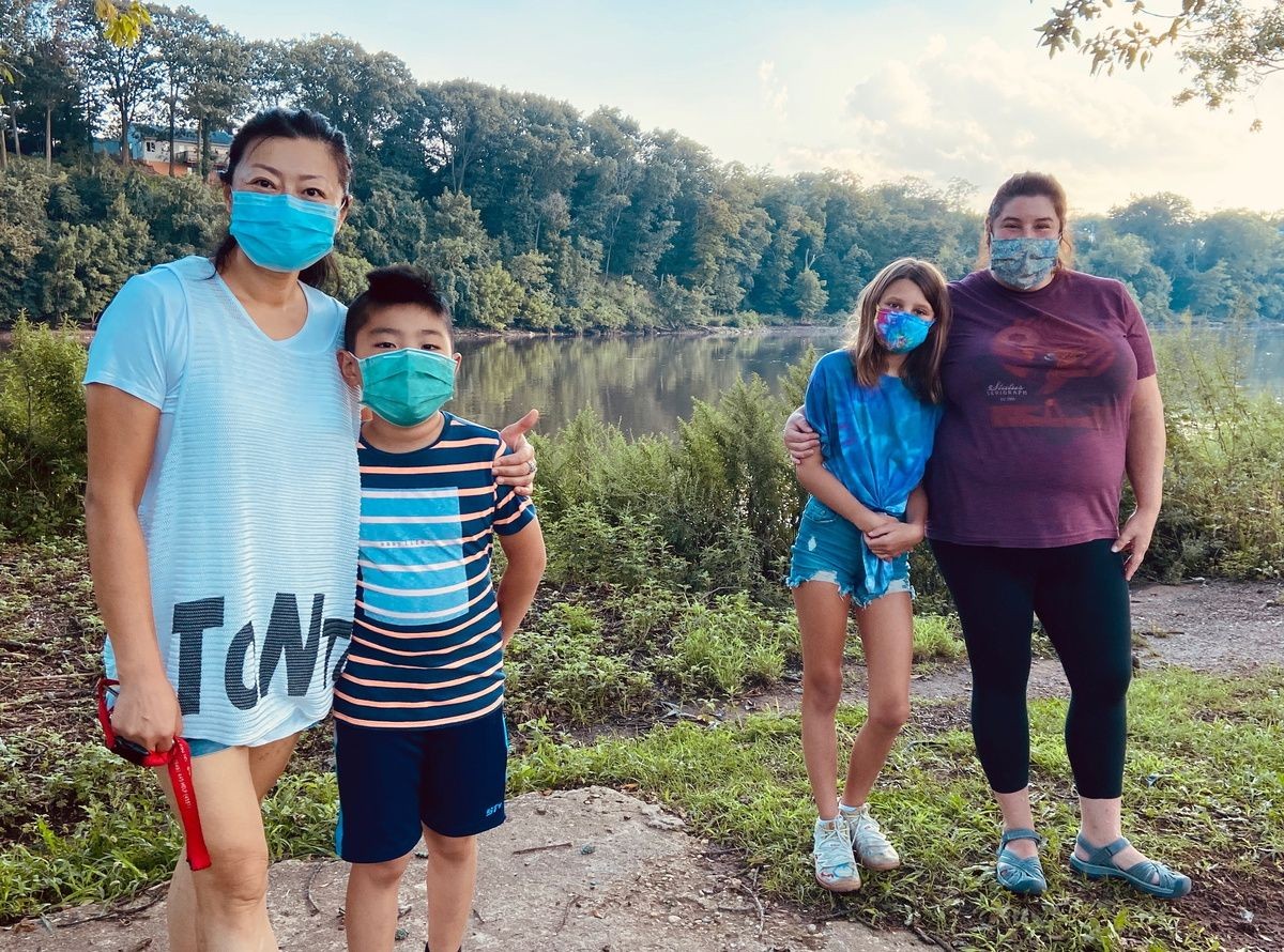 Parents and children outside wearing masks.