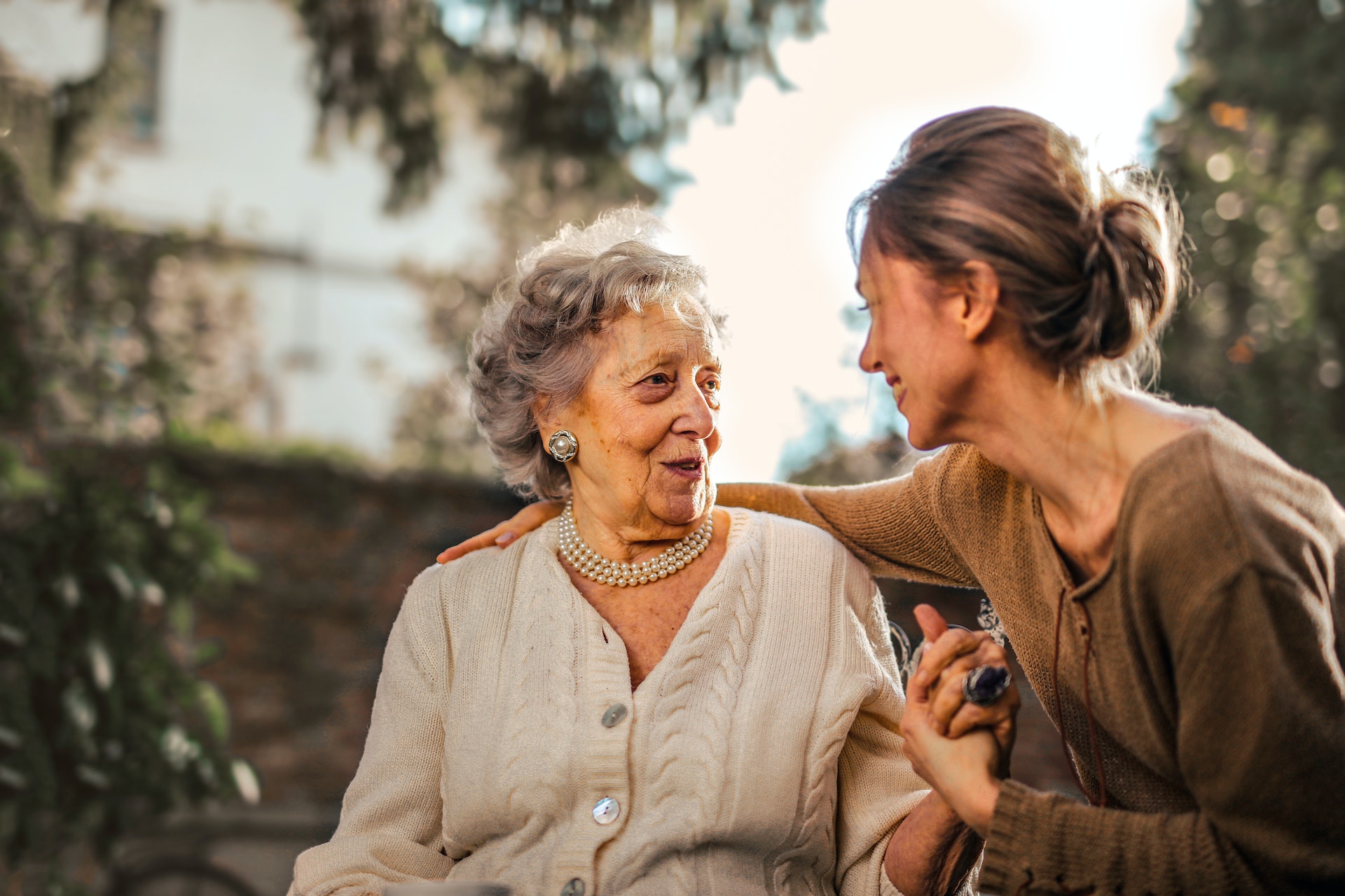 woman speaking with elderly parent