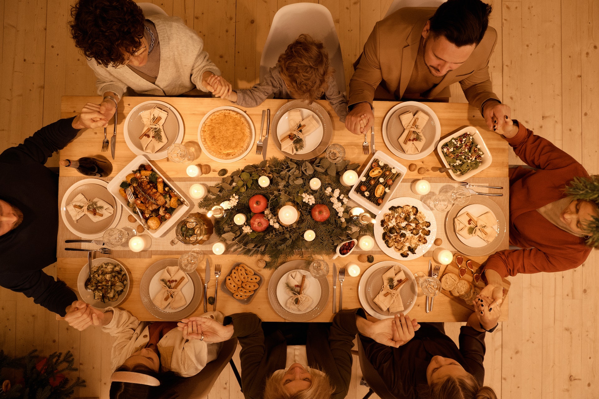 family gathering around table for holiday meal