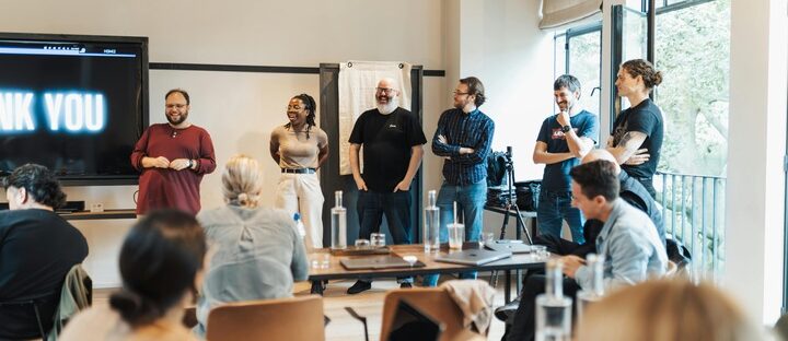 adults in meeting room doing a team-building activity