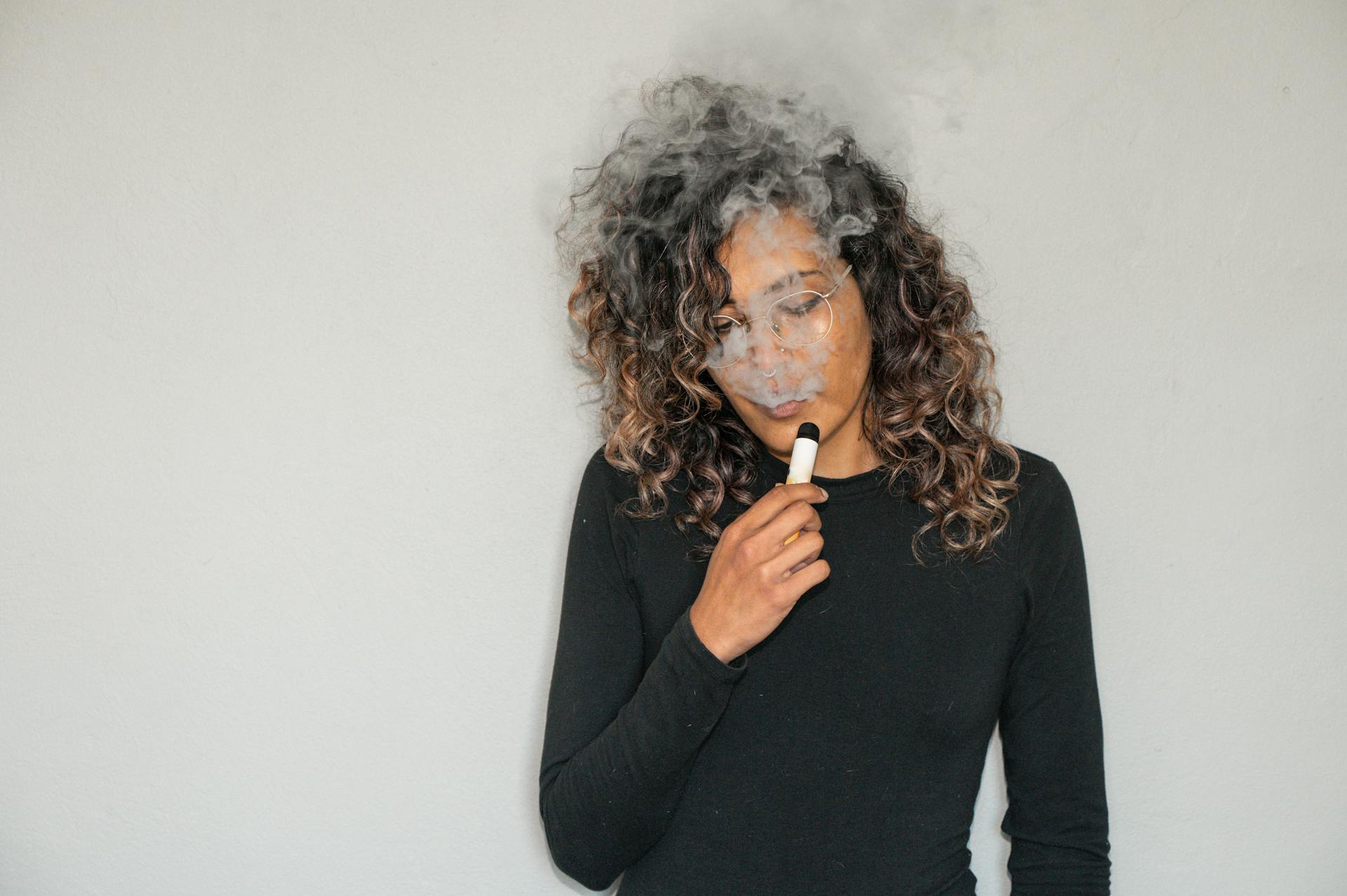 woman using a vape pen