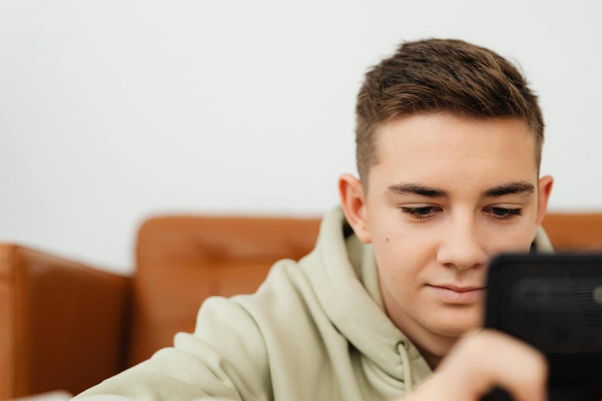 teen boy glued to phone