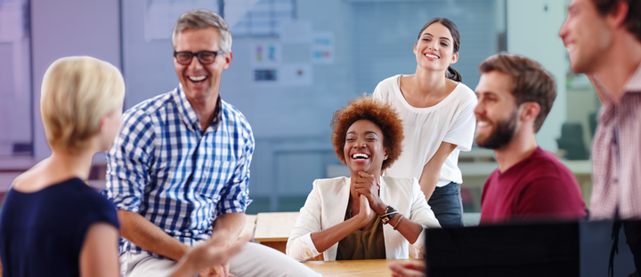 Adults participating in a positive group discussion during a professional self-care training.