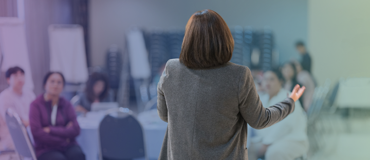 Instructor leading an in-person professional development training for adult learners.