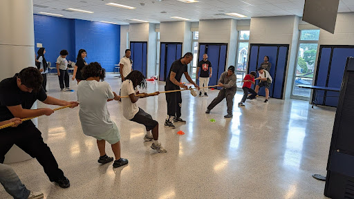 Students participating in a paired indoor exercise during a Pivotal Point summer program session.