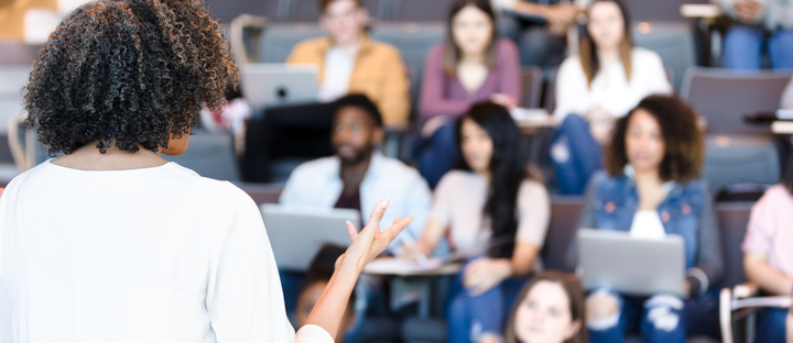 instructor lecturing diverse group of students