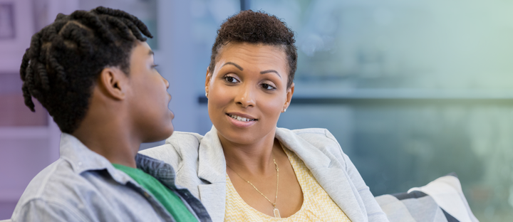 mother having a meaningful conversation with her teenage son at home