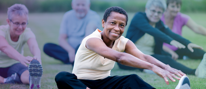 older adults exercising in a park